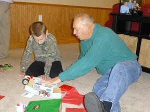 Grandpa explaining where his presents came from...his toy collection. :)